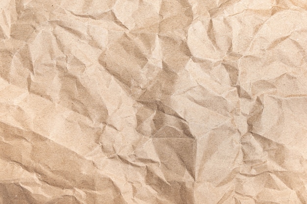 Close up of recycled brown wrinkle crumpled old with paper page\
texture