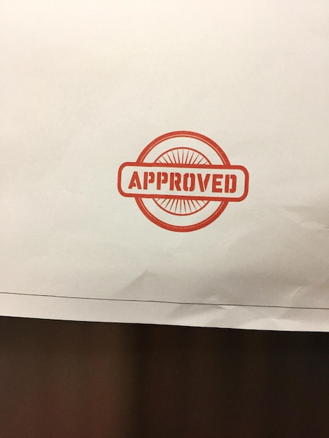 close up of red approved stamp on white sheet