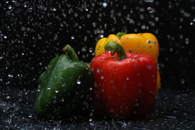 Close-up of red bell peppers against black background