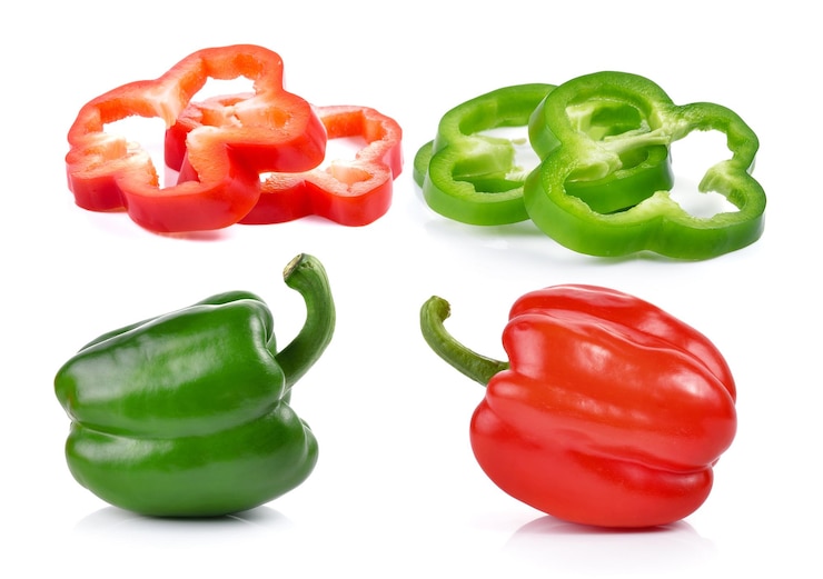 Photo close-up of red bell peppers against white background