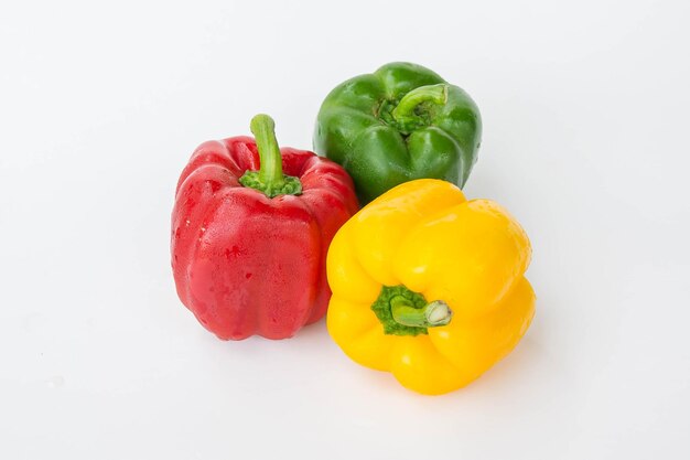 Close-up of red bell peppers against white background