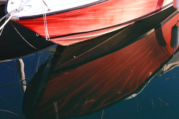 Photo close-up of red boat moored in water