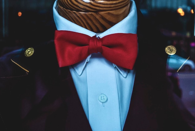 Close-up of red bow tie on mannequin at store window