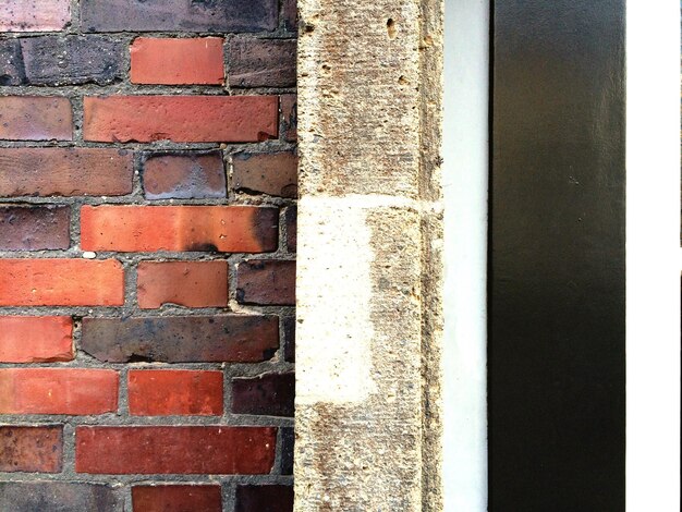 Close-up of red brick wall by door