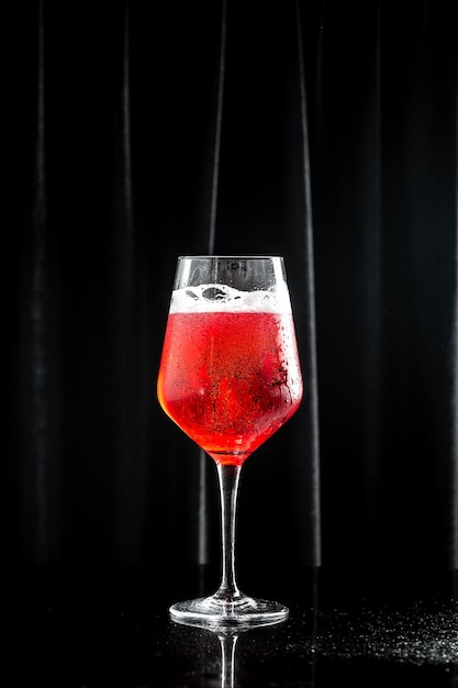 Close up of red champagne glass on a black background drink holidays party concept