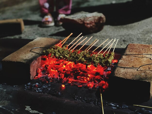 Close-up of red chili peppers on barbecue grill