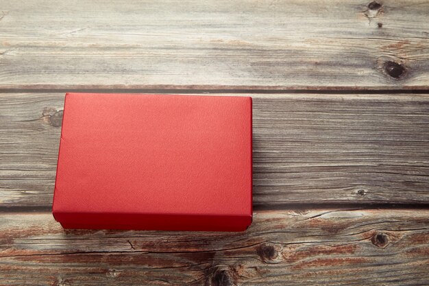 Close-up of red christmas present on table