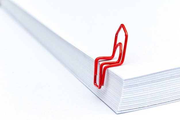 Photo close-up of red clip on papers