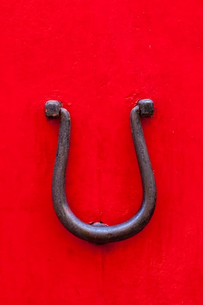 Close-up of red door with metal