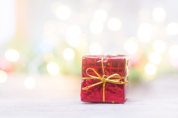 Close up of red gift box for Christmas on blurred lights