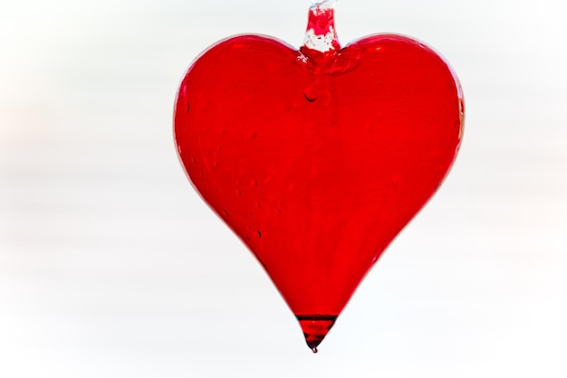 Close-up of red heart shape against white background