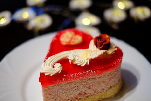 close-up of red heart shape cake in plate on table