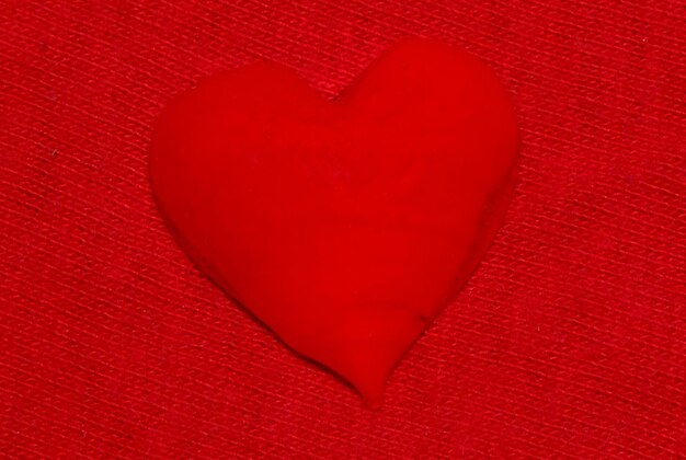 Close-up of red heart shape on white surface