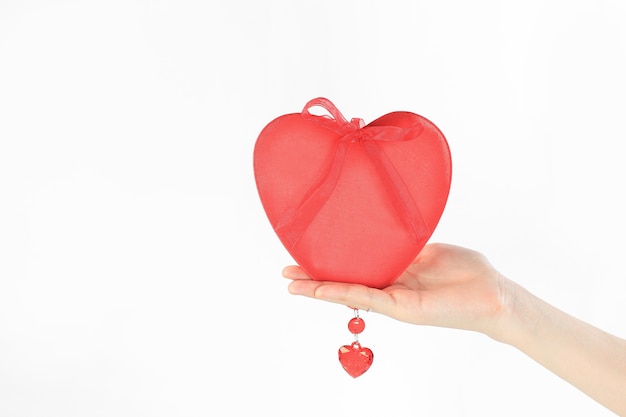 Close up. a red heart in a woman's hand