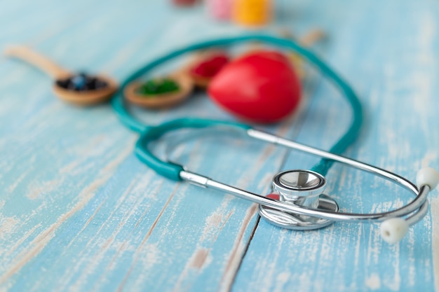 Close-up of red hearts and vitamins.