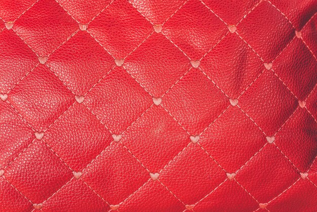 Close-up red leather sofa backrest background