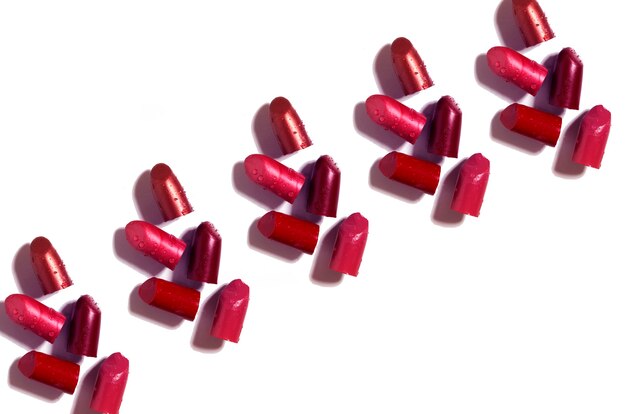 close up of red lipsticks on white background