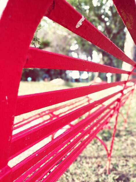 Close-up of red metallic structure in field