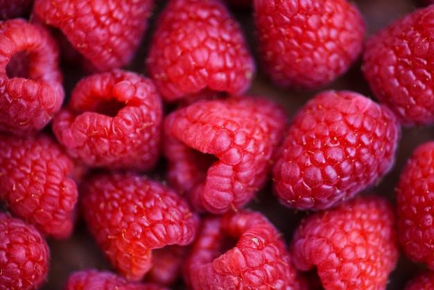 Close up red raspberries fruit background top view