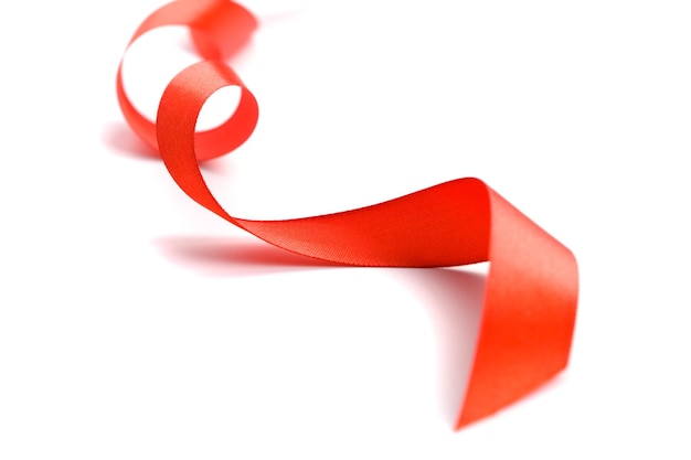 Photo close-up of red ribbon over white background