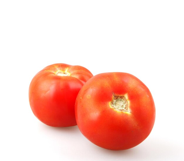 Close-up of red tomatoes on white background