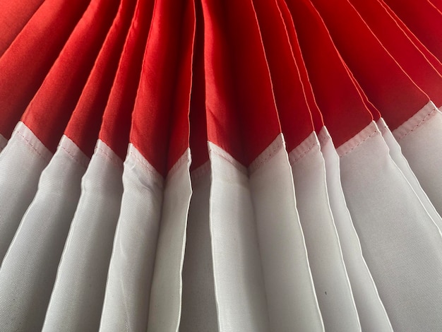 A close up of a red and white pleated skirt