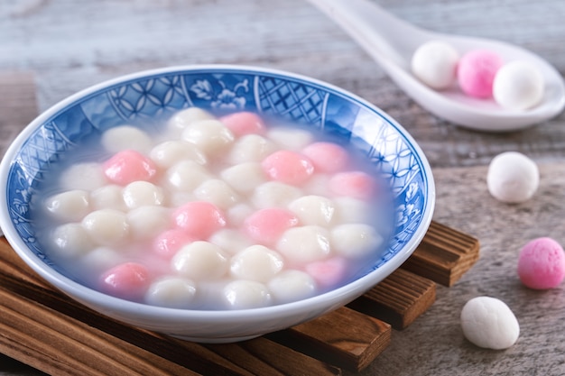 Close up of red and white tangyuan in blue bowl