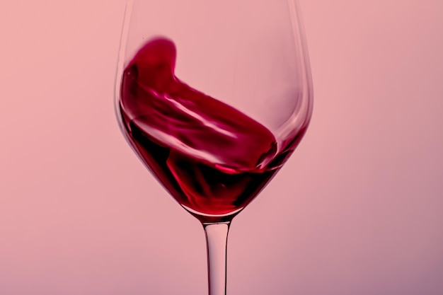 close-up of red wine glass against white background