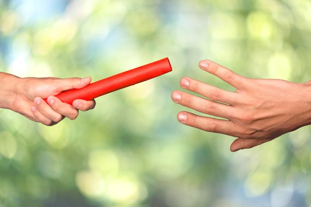 Close-up of relay baton being passed