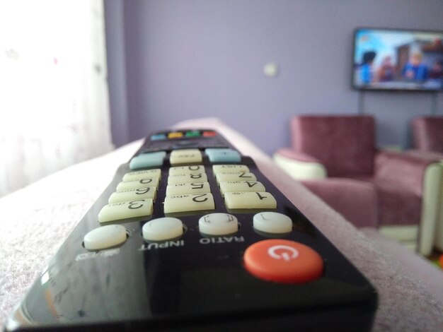 close-up of remote control on seat at home