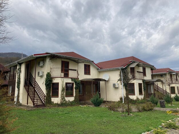 Close up of residential buildings in mountainous terrain Cottage houses in countryside in cloudy weather