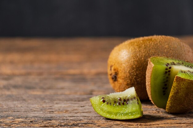 CLose up Ripe kiwi on a wooden background Healthy food Healthy lifestyle Copyspace for text