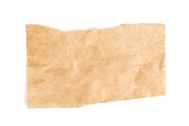 Close up of a ripped piece of brown paper on white surface
