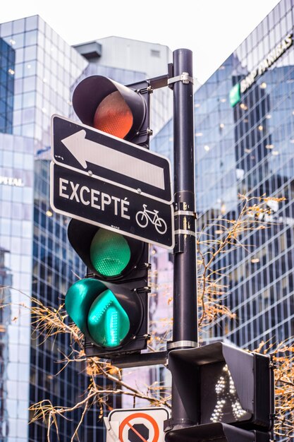 Photo close-up of road sign against buildings in city