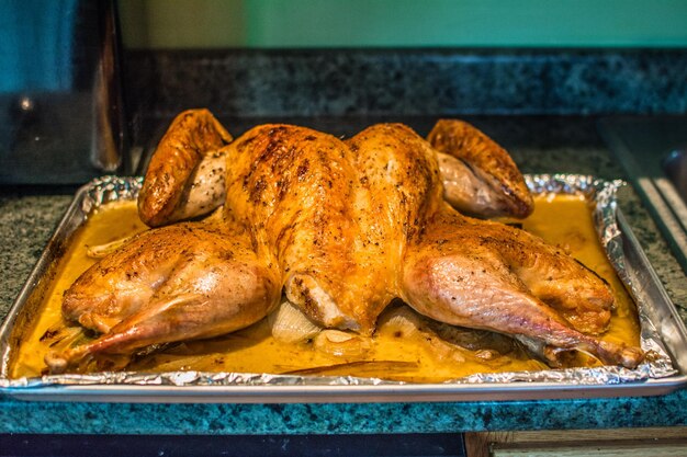 Close-up of roast chicken in baking sheet