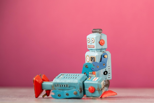 Photo close-up of robot against pink background