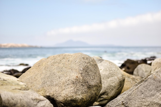 Close-up of rocks on beach against sky