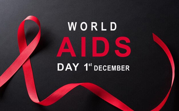 Foto close-up rode lint hiv wereld aids dag bewustzijn lint op zwarte achtergrond gezondheidszorg en geneeskunde concept