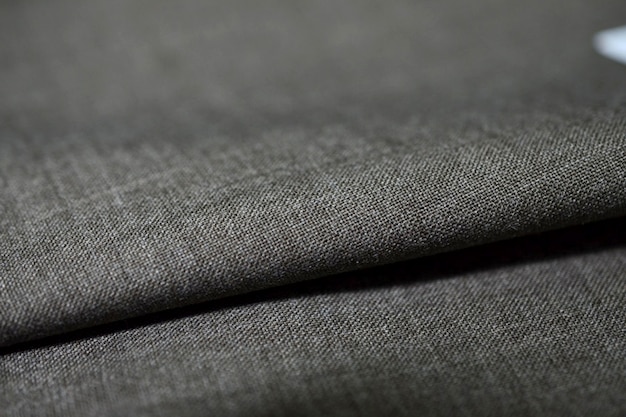 close up roll dark gray fabric of suit