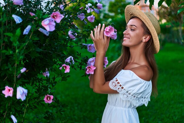 Close up on romantic woman wearing a straw hat