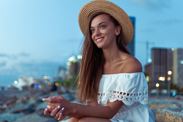 Close up on romantic woman wearing a straw hat
