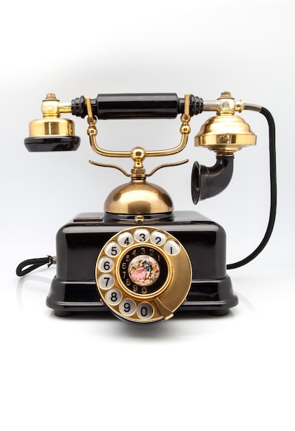 Close-up of rotary phone against white background