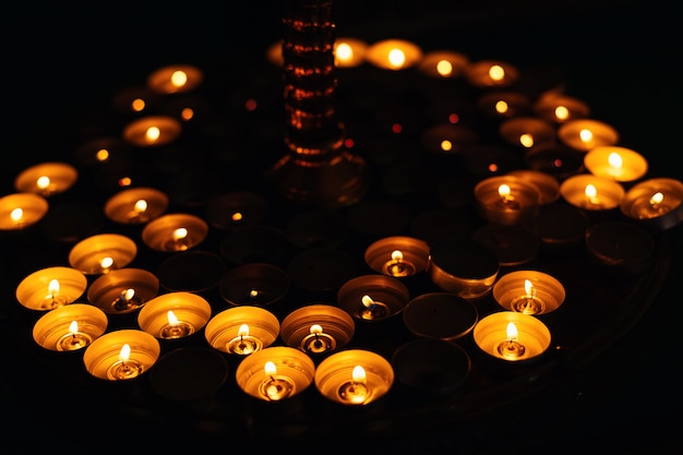 A close-up of a round candlestick with many small round candles