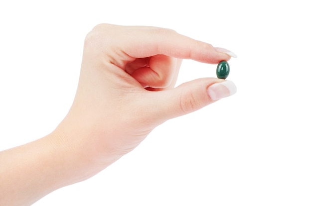 Close up round white pill in hand