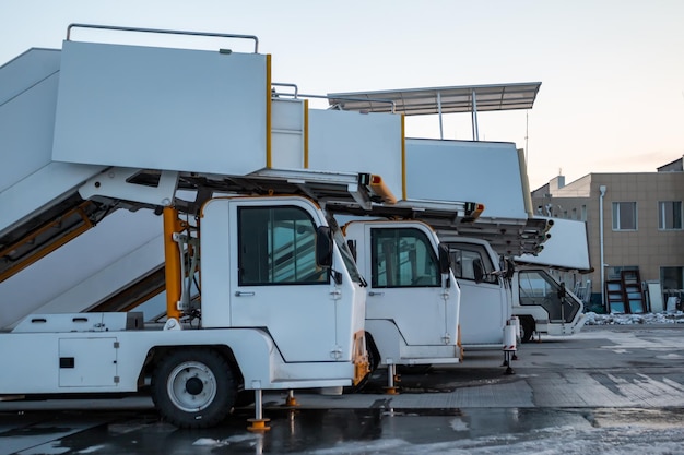 Close-up of row aircraft mobile gangway for boarding and disembarking passengers at the parking lot