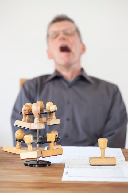 Photo close-up of rubber stamps on table with man in background