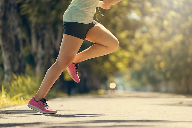 Close up of runner legs running in the park 