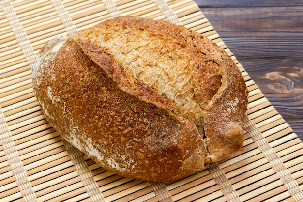 Close up of rustic loaf of bread on wooden table