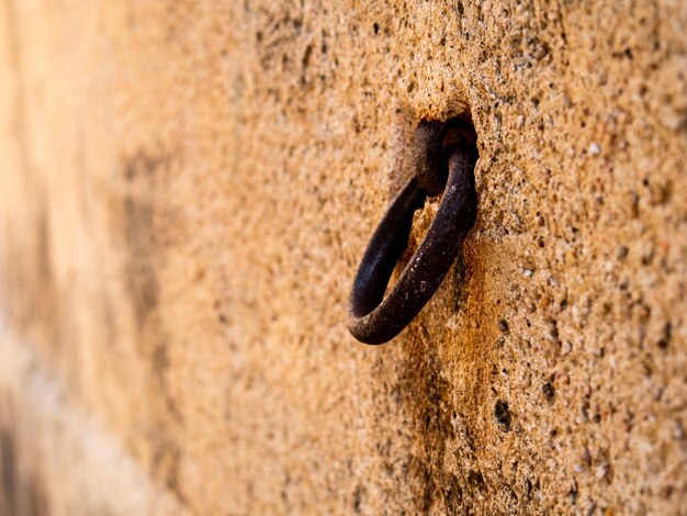 Foto close-up di una catena arrugginita sul muro