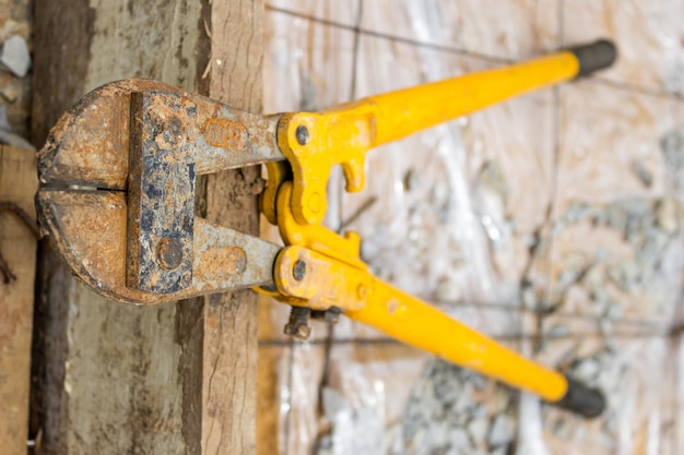 Close-up of rusty work tool on workbench in factory